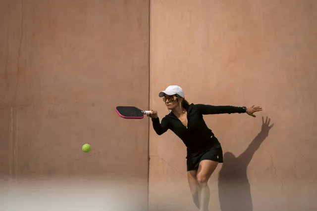 A recreational pickleball player preparing to hit the ball